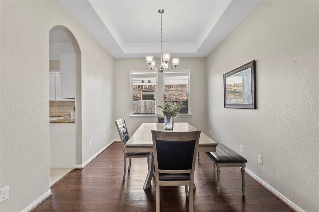 Your dining room welcomes every meal with warmth and grace, from quick breakfasts to cozy holiday dinners. The tray ceiling adds an elegant touch, while natural light from the twin windows makes even everyday meals feel like a moment.