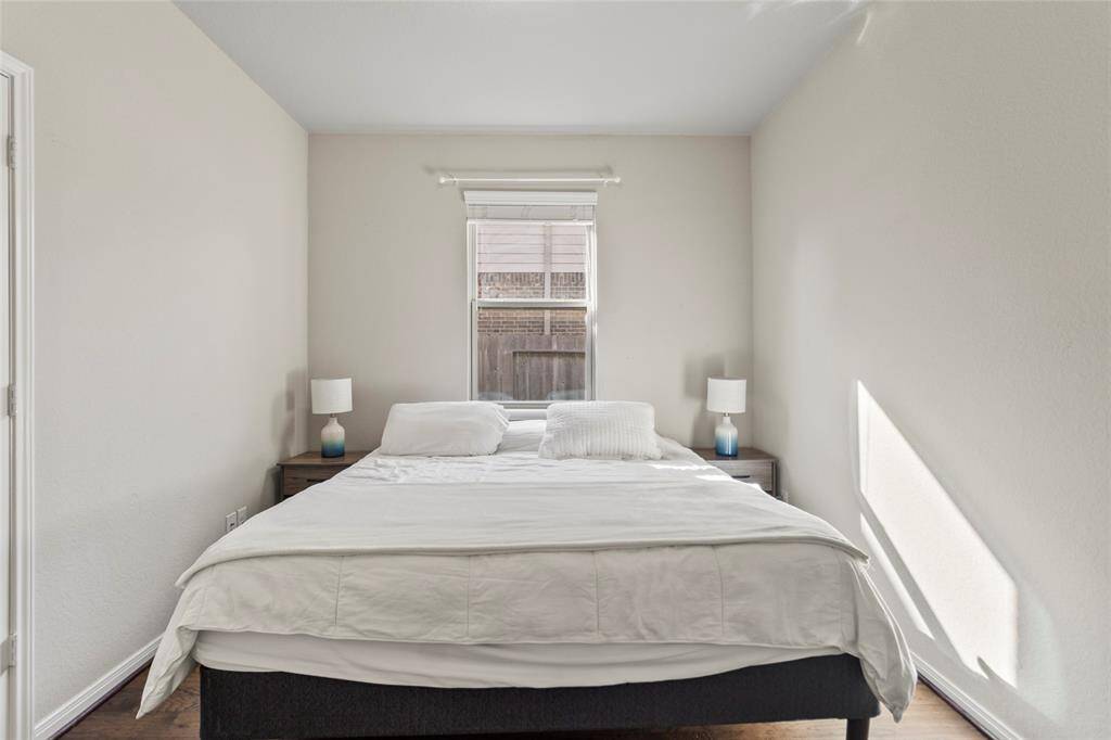 Your secondary bedroom offers a peaceful, sunlit corner perfect for guests or a quiet retreat. The neutral tones and simple layout make it easy to make this space your own.