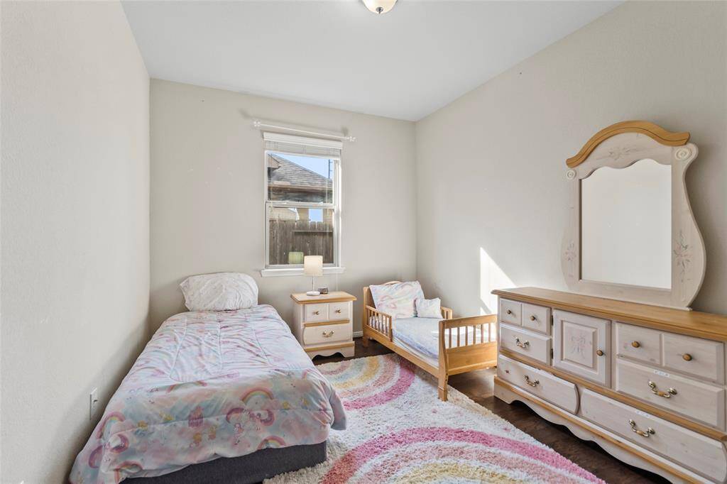 Sunlight pours into this cozy room, bouncing off soft neutral walls and warm wood flooring. It’s the perfect space to play, read, or unwind—quietly tucked away for comfort and calm.