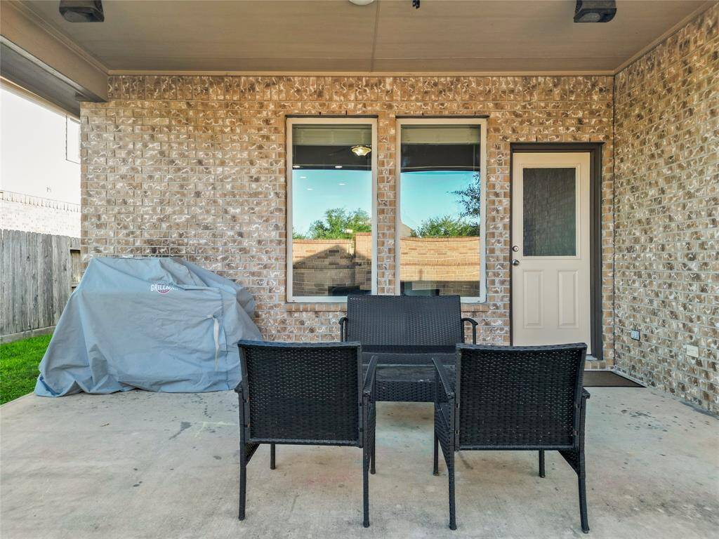 Enjoy the ease of outdoor living on your covered back patio—perfect for grilling, relaxing, or sipping your morning coffee. With direct access from inside and space for seating or a small dining setup, it’s a low-maintenance extension of your home that’s ready for everyday moments or casual entertaining.