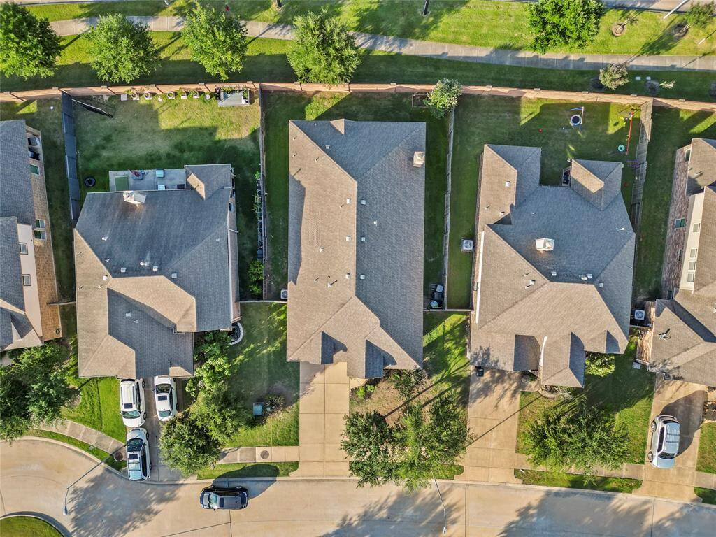 This aerial view showcases the property’s well-maintained roofline, private backyard, and extended driveway. With no direct rear neighbors and a brick wall at the back, you’ll enjoy extra privacy in a peaceful setting—all within a quiet, cul-de-sac-style street layout.
