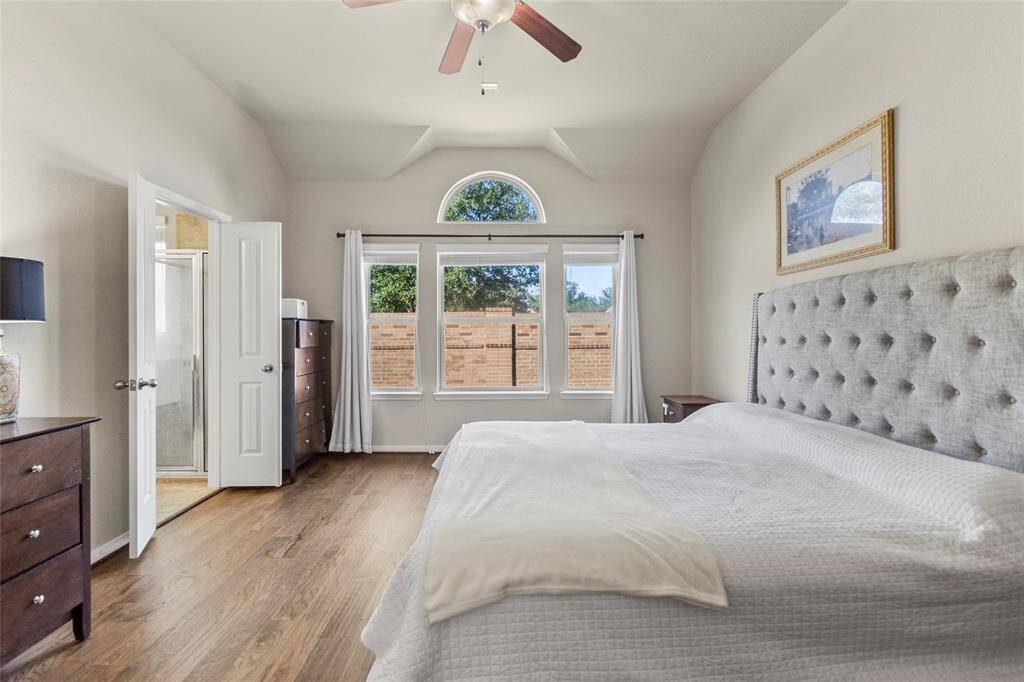 Wake up to sunlight streaming through those tall windows, casting a soft glow on the hardwood floors. The brick privacy wall just outside keeps things calm and quiet. Mornings feel slower here, more intentional.