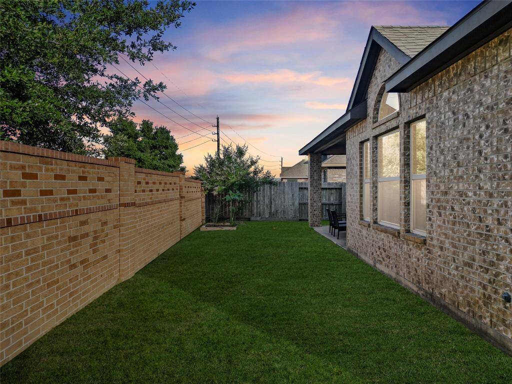 A fully fenced backyard offers both privacy and peace of mind—ideal for pets, kids, or just unwinding outdoors. With a low-maintenance lawn, brick perimeter wall, and covered patio access, this space is ready for gardening, relaxing, or weekend BBQs.
