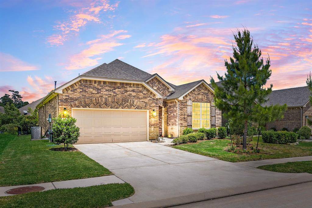239 Spotted Saddle Ct is a charming single-story brick home with a two-car garage, well-maintained landscaping, and a 2 car wide  driveway. A very appealing elevation and well cared for landscaping both enhances the home's inviting appearance.