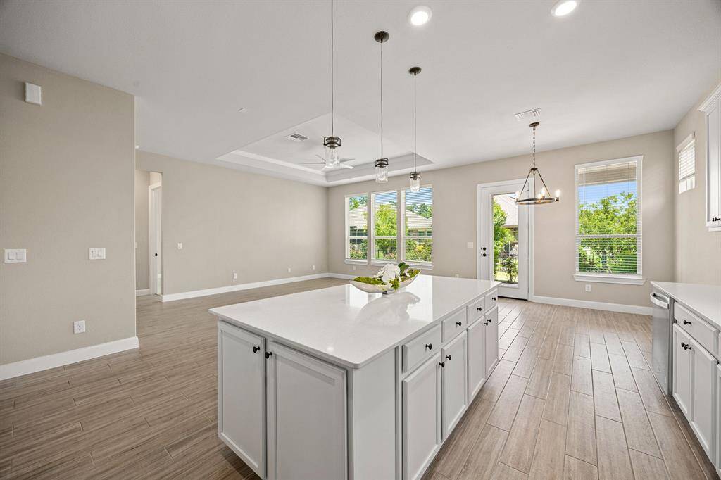 Wall of windows makes this open concept area feel quite open with unobstructed views out to the landscaped backyard.