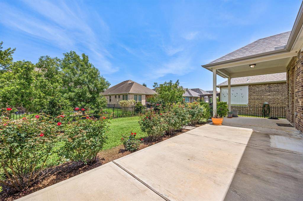 Delight in your nicely landscaped back yard. Quite spacious with a covered patio and open patio space for entertaining family and friends.