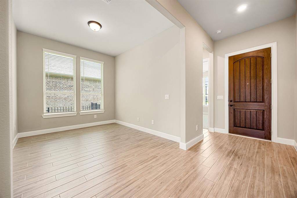 View of formal dining room to front door and secondary bedroom.