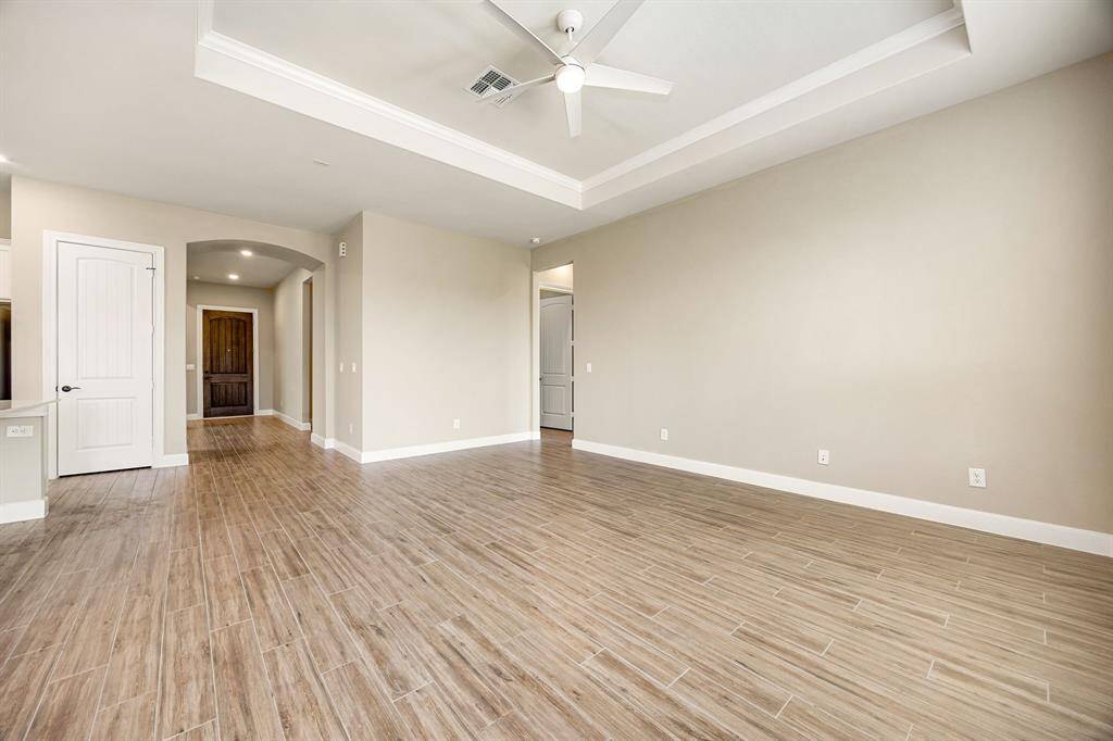 Large living room with a tray ceiling adding architectural detail to this room.