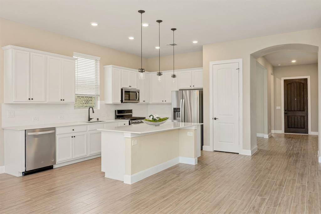 The kitchen features a large island with bar seating.