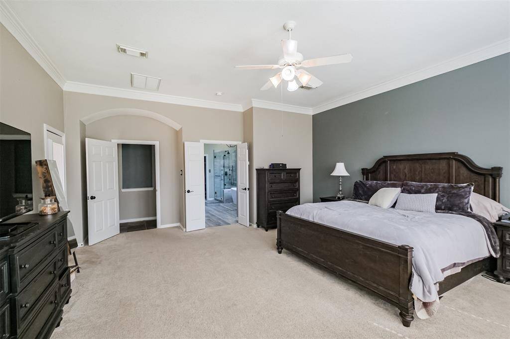 A view of the large primary suite and  updated bathroom.