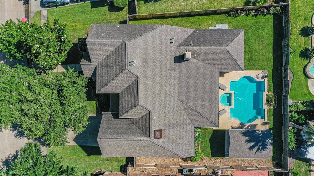 Stunning aerial view showcasing the property's spacious layout and inviting pool.
