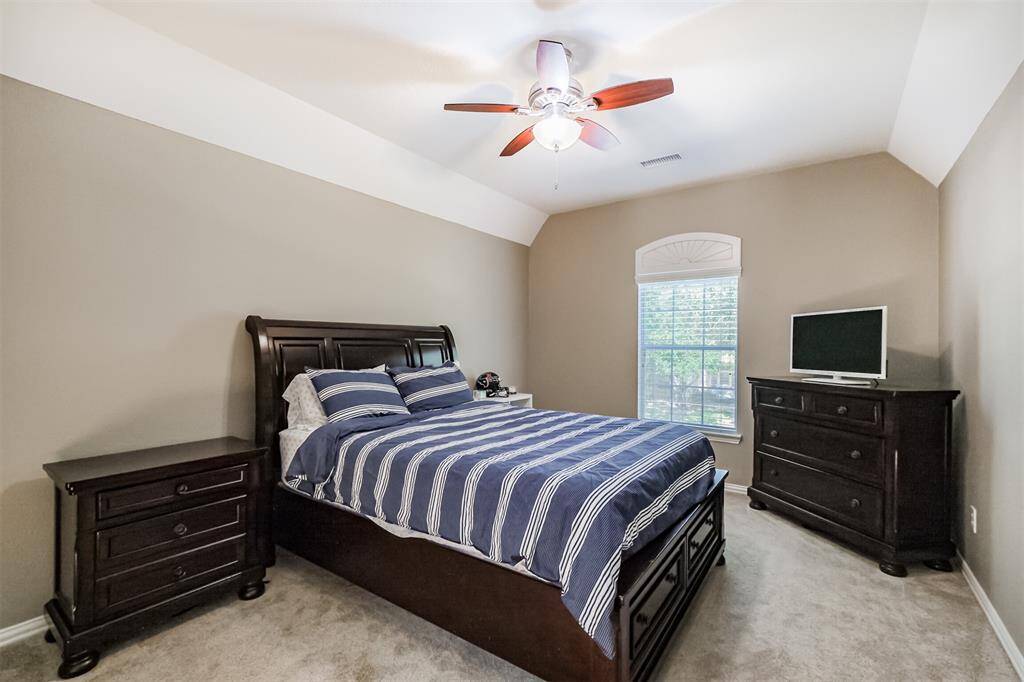 Spacious second-floor bedroom with ample natural light. This room is conveniently right at the top of the rear stairway.
