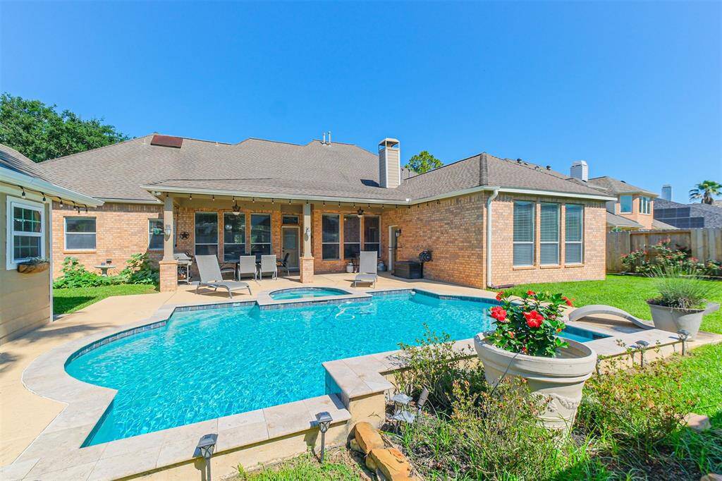 Stunning backyard oasis with a sparkling pool and inviting patio, perfect for relaxation and entertaining.