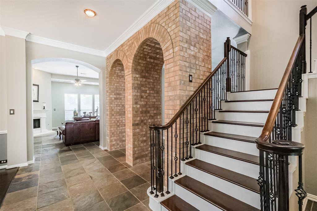 The updated front stairs are complemented by stunning brick archways and refined crown molding.