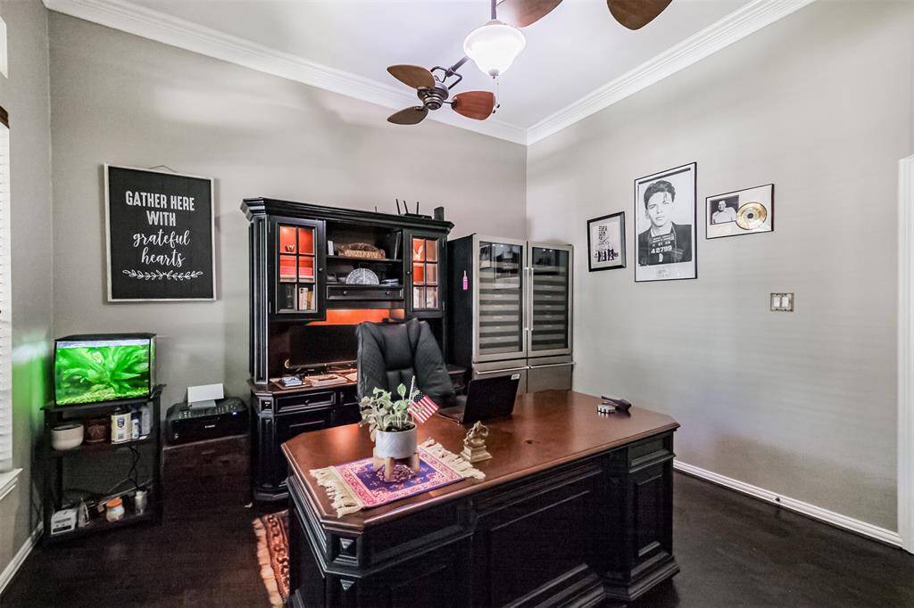 Experience privacy for remote work in the front study, featuring elegant engineered wood floors and stylish French doors.