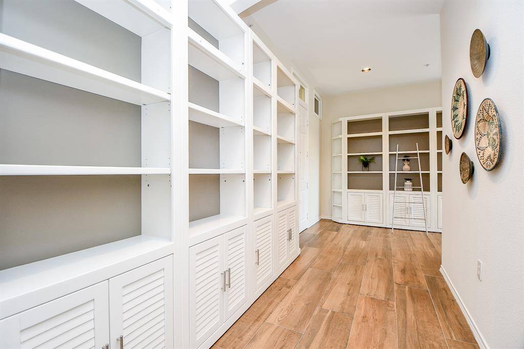 Hallway also has custom bookcase- shelving that is removable