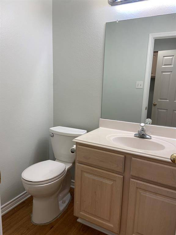 The half-bath is located downstairs, between the living room and kitchen.