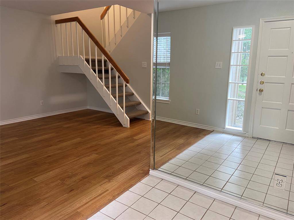 The mirrored entry reflects the sunlight back into the room. There is enough space for an entry table, coat rack, or even a wardrobe.