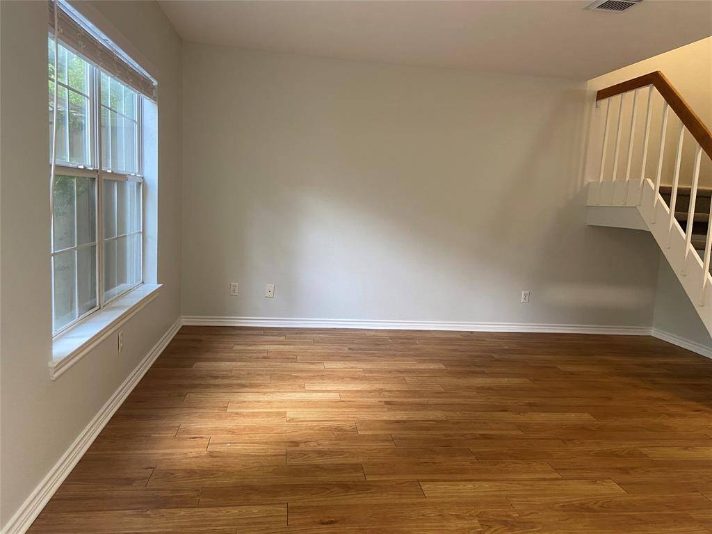 Large windows fill the living room with soft light.