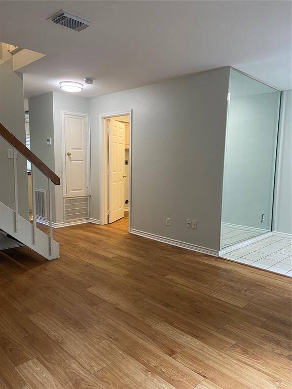 The door at the bottom of the staircase leads to the laundry room and half bath. The opening to the left takes you to the kitchen and dining area.