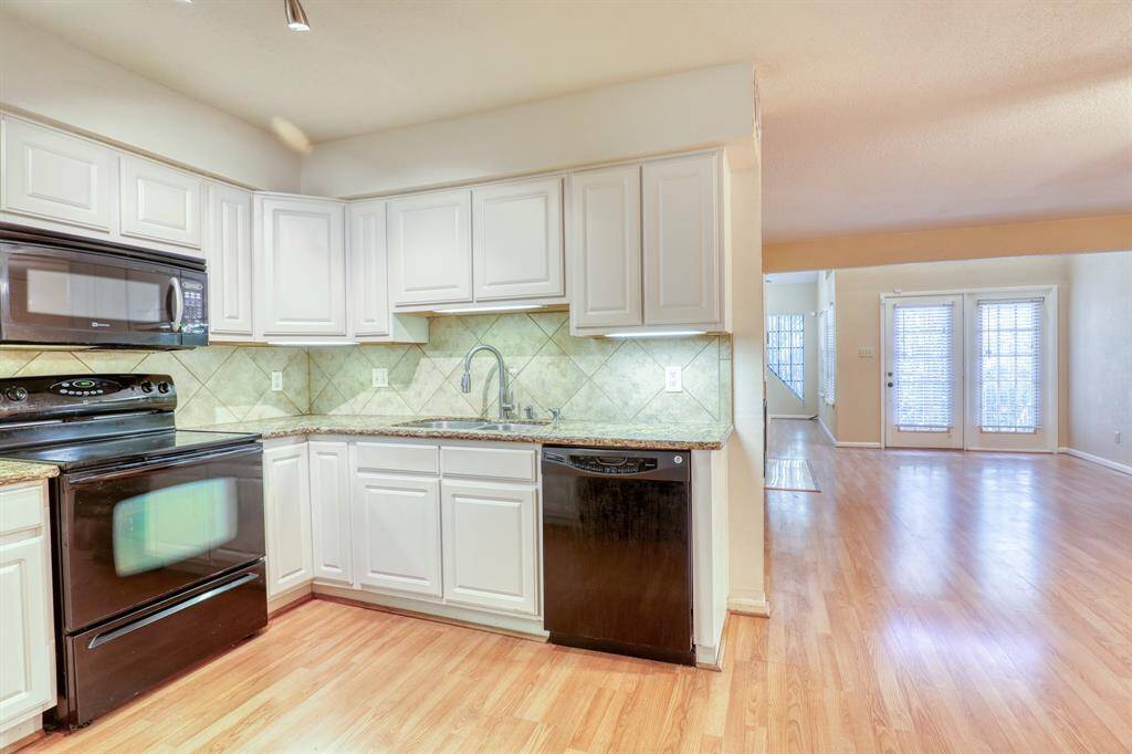 The updated kitchen is open to the living/dining area.