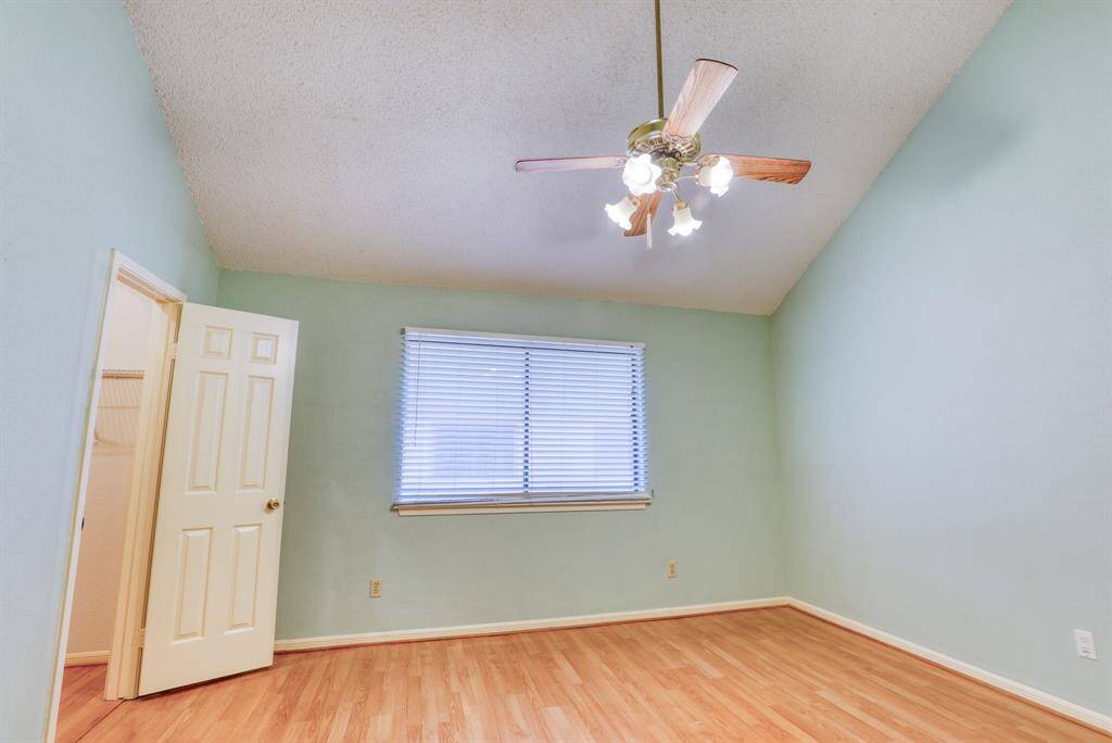 The first floor bedroom features high ceilings and a spacious walk-in closet.