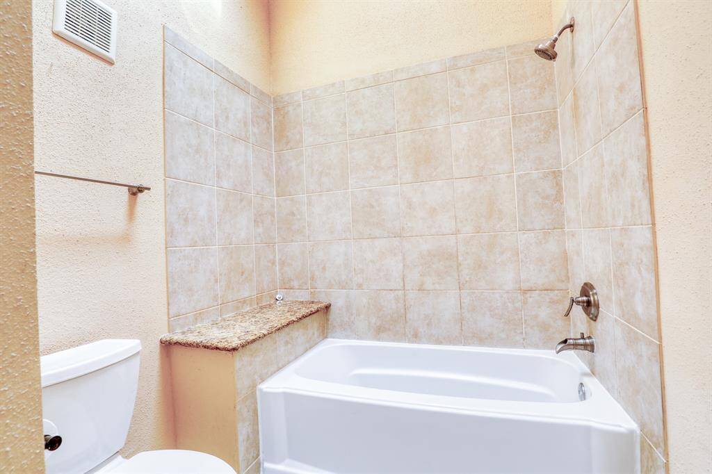 The first floor bathroom includes a large tub/shower combo.