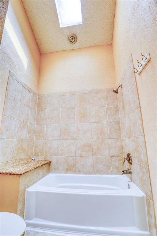 First floor bath also features high ceilings and a skylight for lots of natural light.