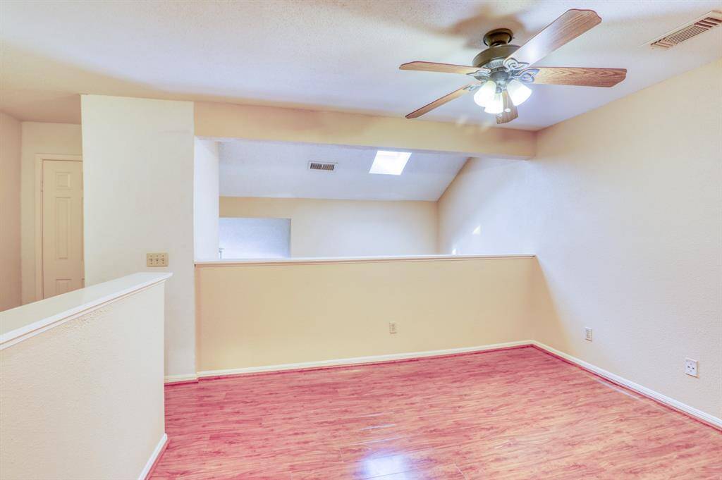 The primary bedroom is loft-style and open to the first floor. Tall windows and a skylight allow lots of natural light into this space.