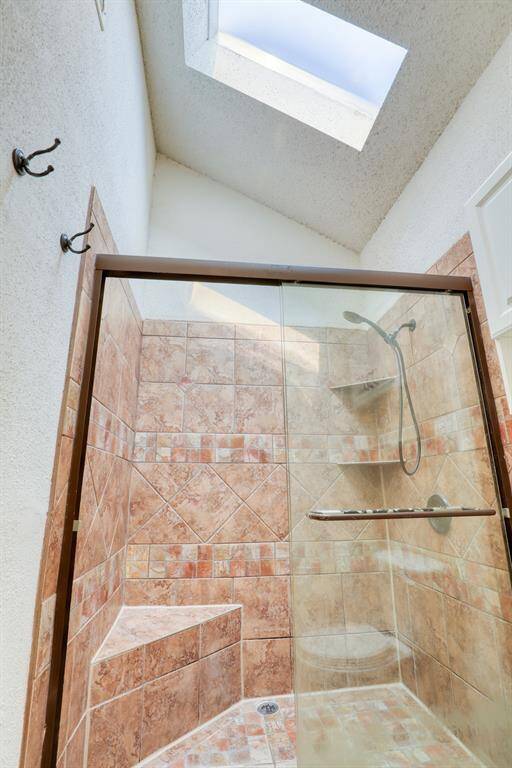 High ceilings and another skylight in the primary bath.