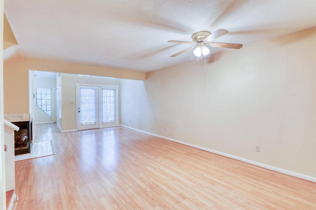 Large living area features laminate floors and lots of windows for natural light.