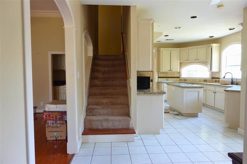 Open Floor Plan with View of Kitchen and Stairs