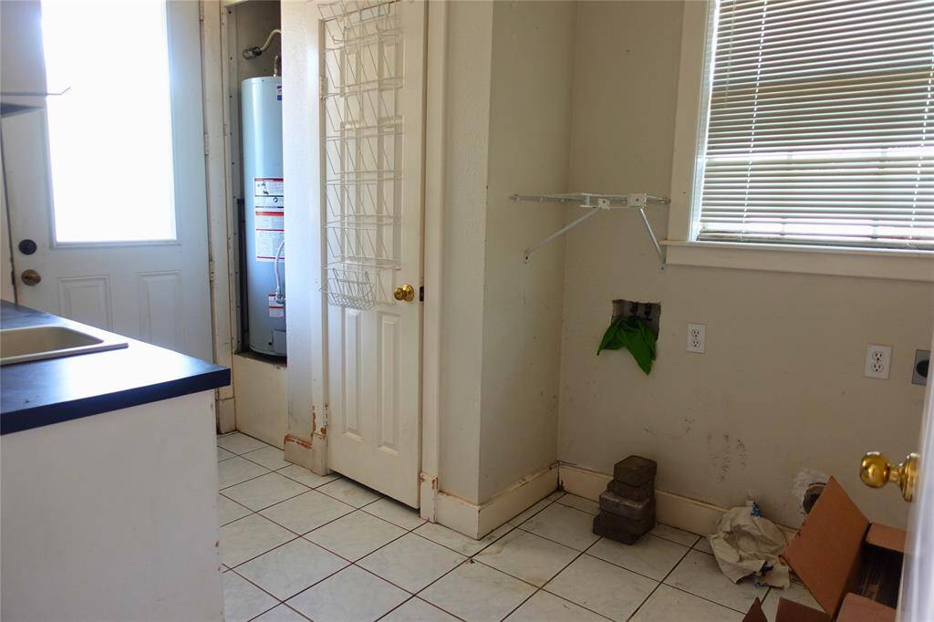 Utility Room with Exterior Access & Water Heater