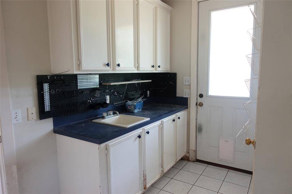 Utility Workspace with Cabinet Storage and Sink