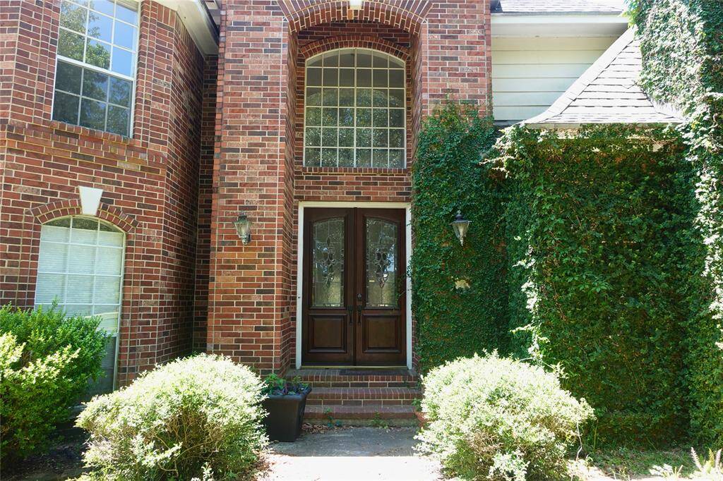 Elegant Double Door Entry Framed by Ivy