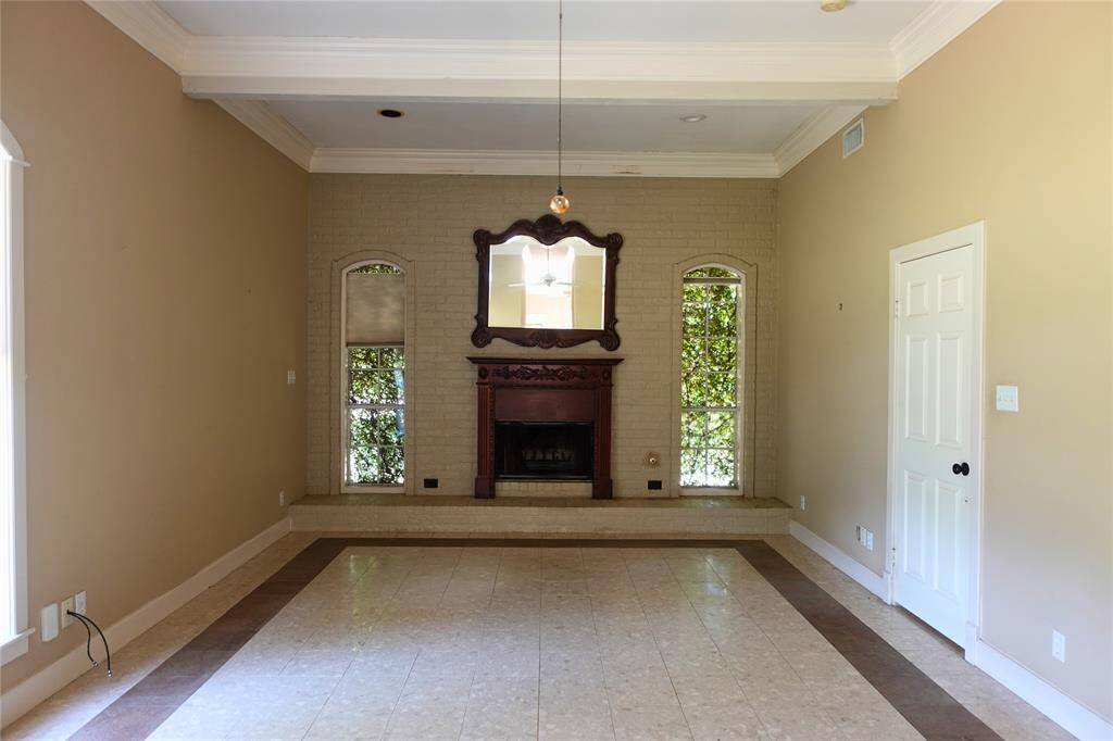 Spacious Primary Bedroom with Fireplace and Crown Molding