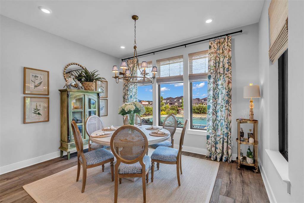 The spacious dining area off the kitchen and family room overlooks the scenic backyard. Upgraded lighting is the perfect finishing touch.