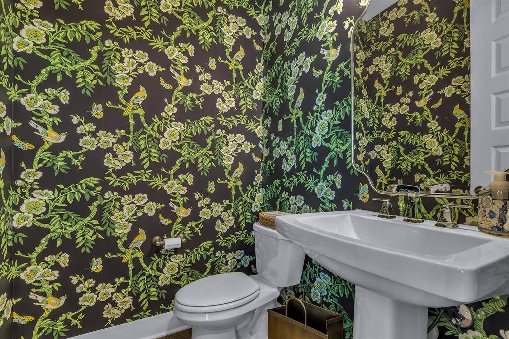 Roomy Powder Bath downstairs with custom wallpaper.