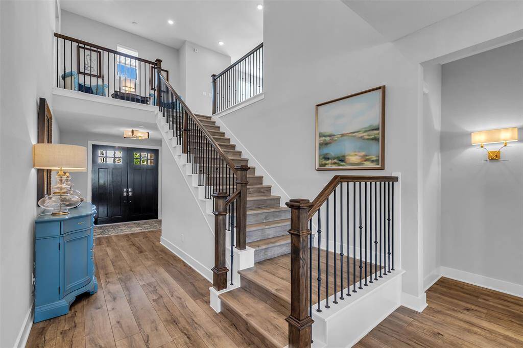 The stunning wrought iron staircase and wood-like tile floors lead to the heart of the home.