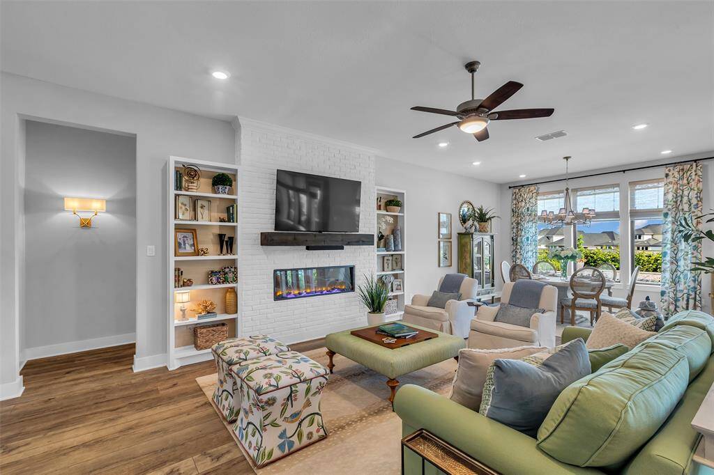 Gorgeous custom brick wall with electric fireplace, and custom built-ins complete the space.