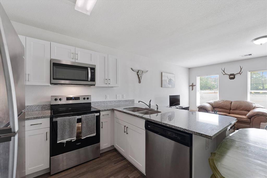 White cabinetry, dual basin sink.