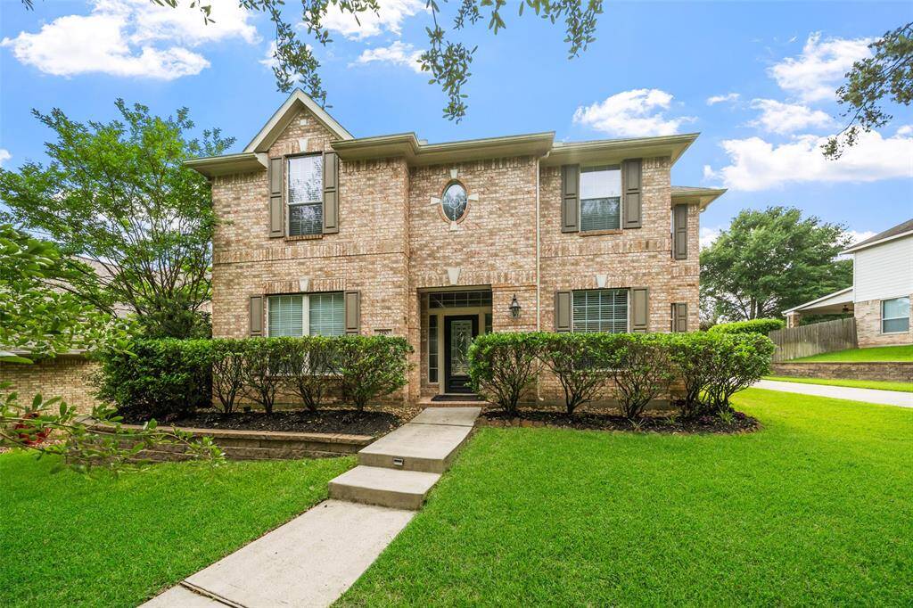 Spacious driveway leading to a detached three car garage