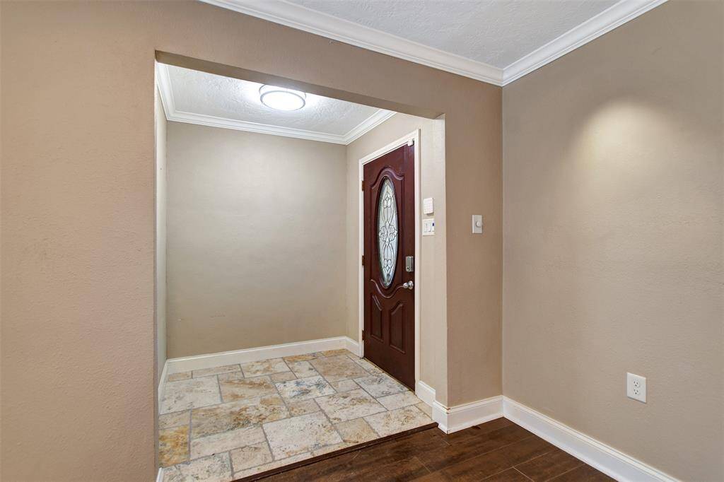 Inviting entryway with a decorative wooden front door for a welcoming atmosphere.