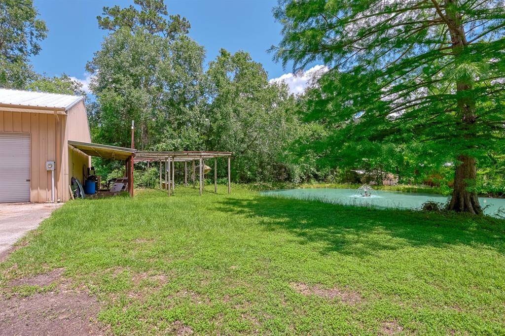 back of property with large pond and fountain