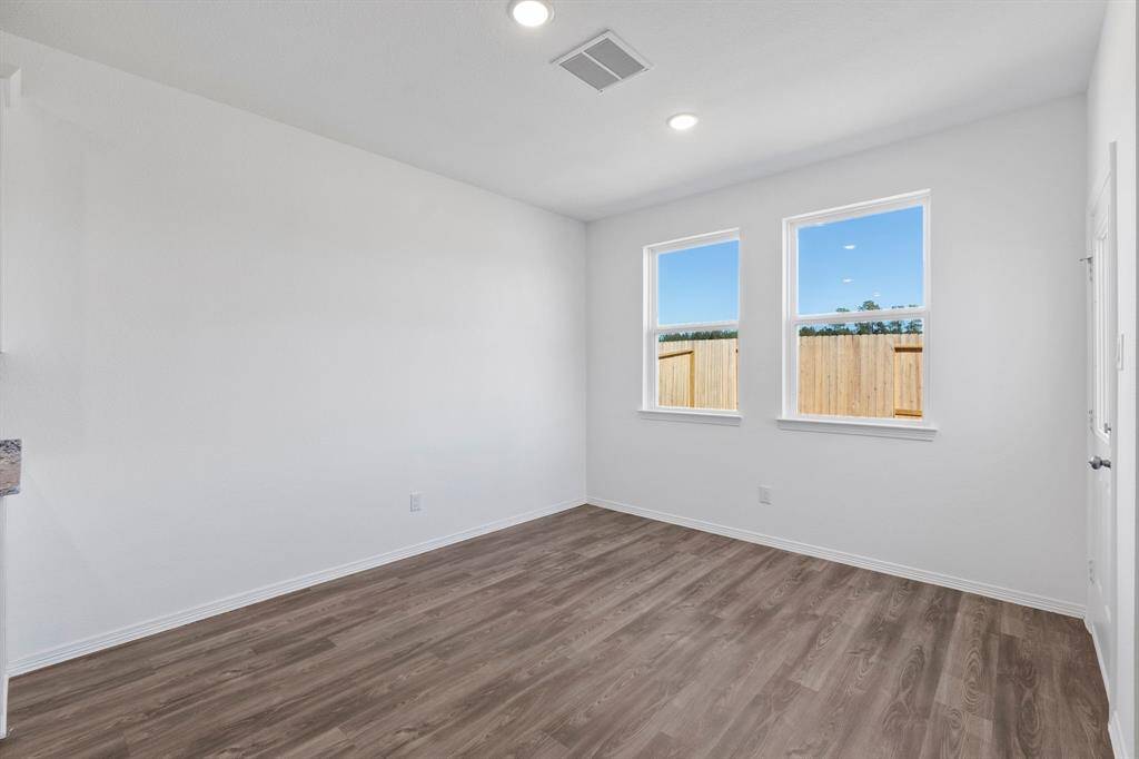 Breakfast/dining nook located right by the kitchen. Blinds have been installed.