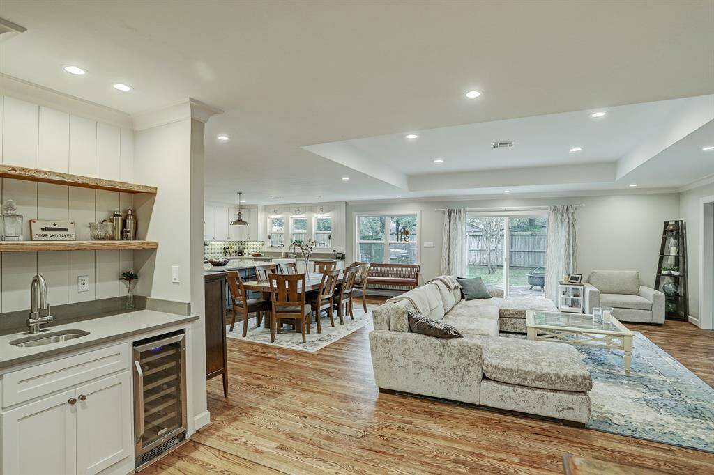 The front porch leads into this front living room complete with hardwood floors and wet bar with wine fridge.