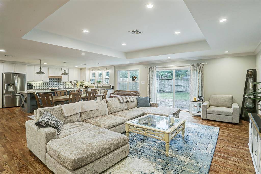 The family room is open to the dining area and kitchen. A wall of windows provides views and access to the back yard.