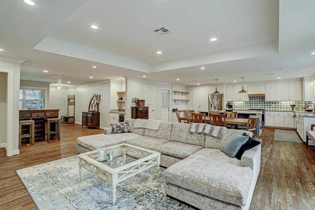 This view shows the front living room and entry off the porch. Note the raised ceiling in the family room.
