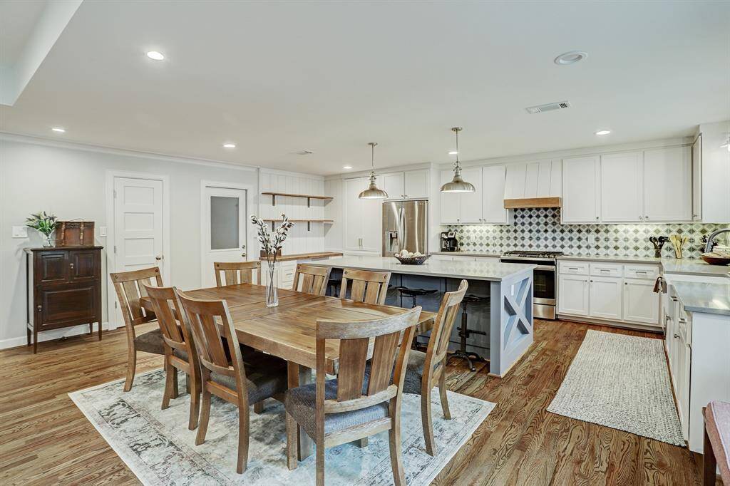 The dining area can easily seat 8-10 people, and the island can seat 4. The kitchen has an abundance of cabinets, built-in desk area, and two pantries!