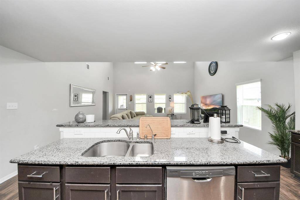 Kitchen connects directly to utility room and hallway for added convenience.